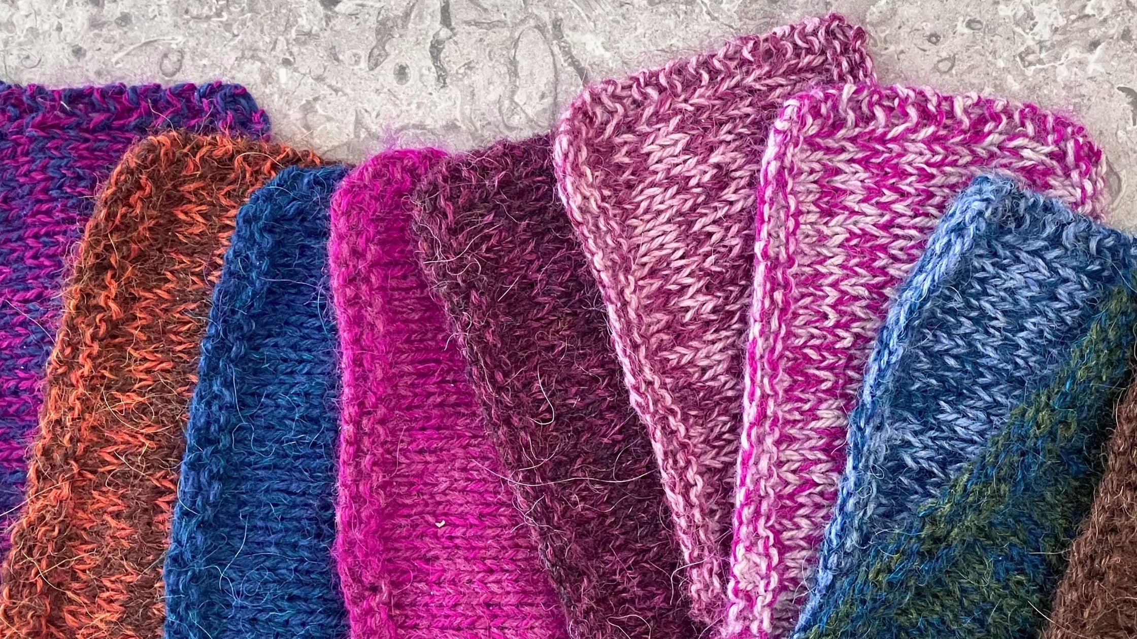 Selection of knitted swatch of Holst Garn Titicaca alpaca lace held double with Supersoft, Coast, & Tides. Various colours and blends.