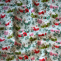 Fabric with a holiday village pattern featuring houses and trees.