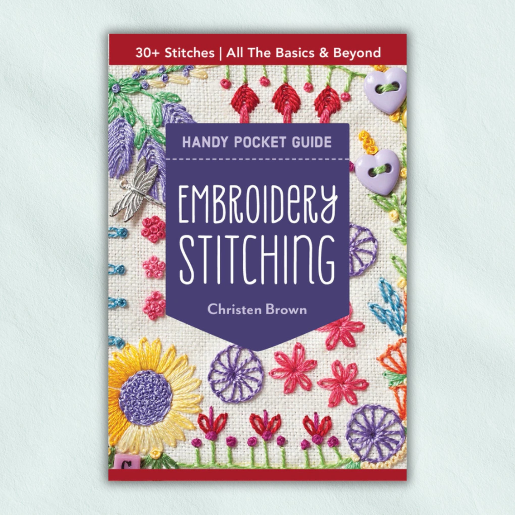 Book cover of 'Handy Pocket Guide: Embroidery Stitching' by Christen Brown with colourful embroidery designs