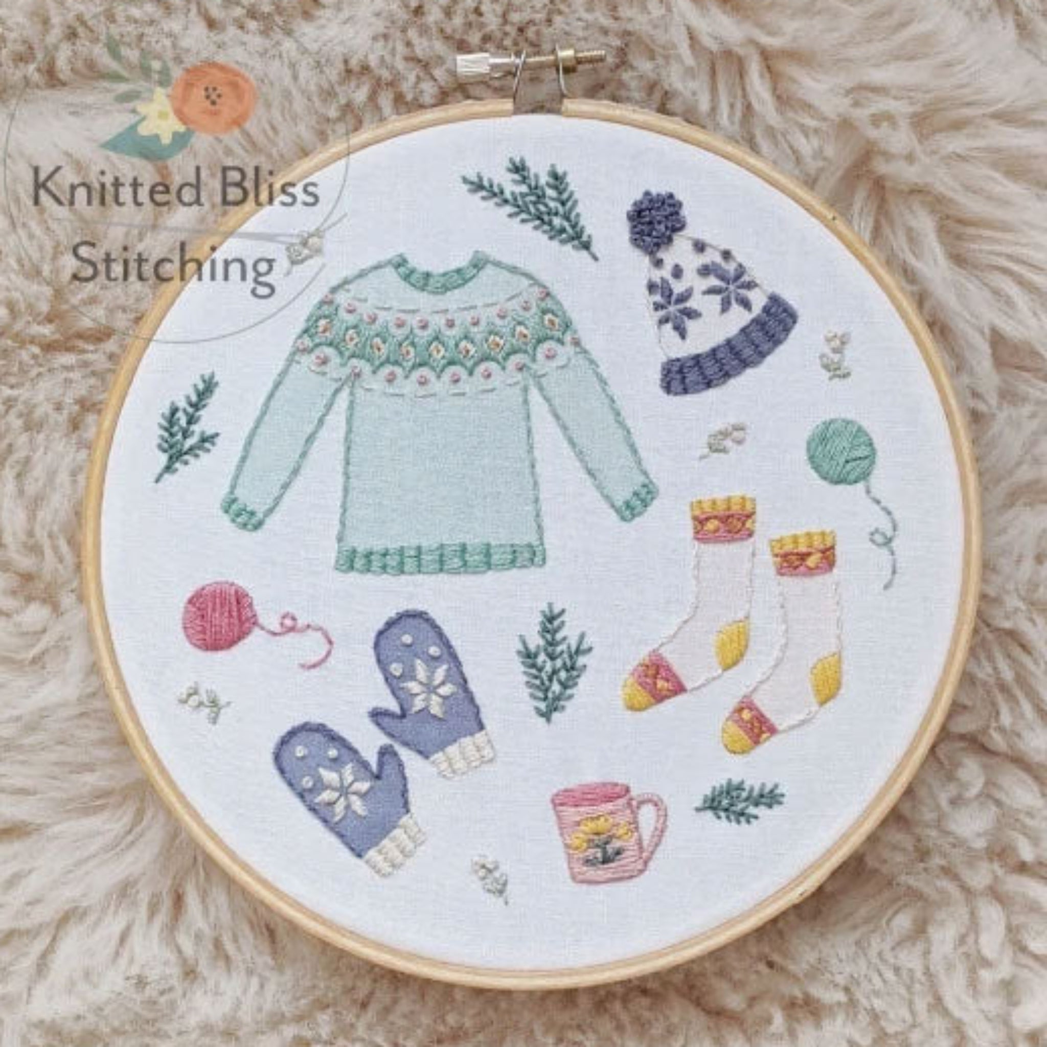 he Wooliest Season embroidery kit by Knitted Bliss — cozy winter design preprinted on 100% cotton with bamboo hoop. Canadian-made.

