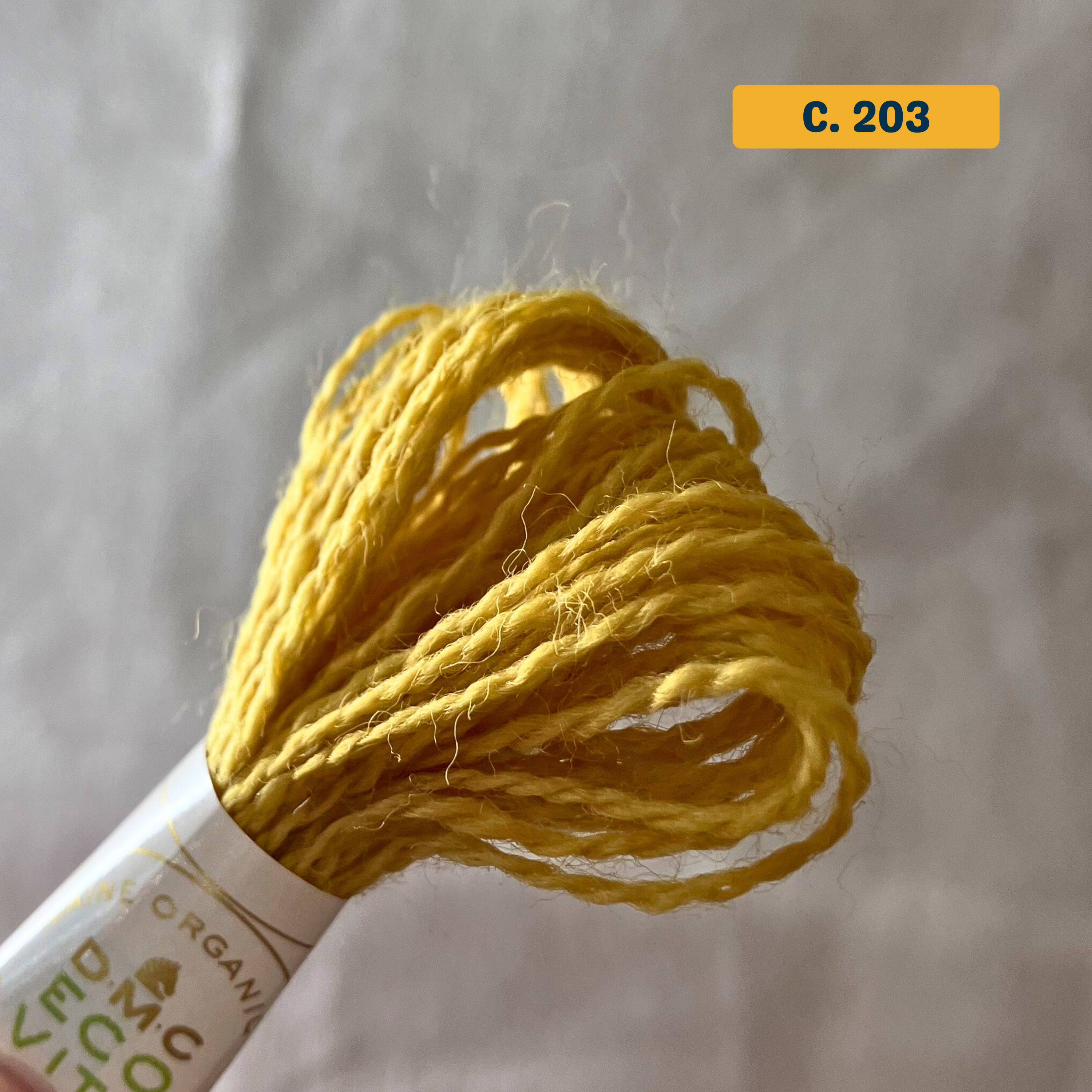 100% Organic Wool Thread — yellow (203). Naturally-Dyed. 16m. 'Organic DMC ECO VITA' label visible. 