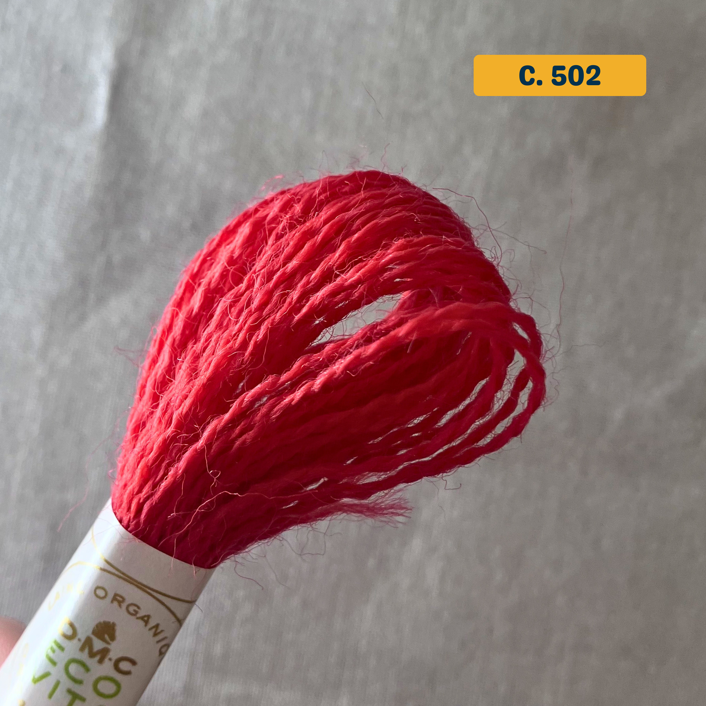100% Organic Wool Thread — bright red (502). Naturally-Dyed. 16m. 'Organic DMC ECO VITA' label visible. 