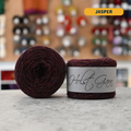50g  dark red-brown (jasper) merino & shetland wool light fingering yarn, 'Holst Garn' label visible, craft shop background (blurred)