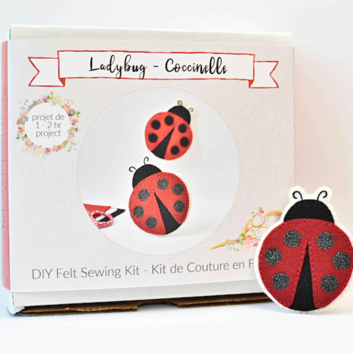 Ladybug felt sewing kit shown with its product box and a completed ladybug felt patch on a white background.