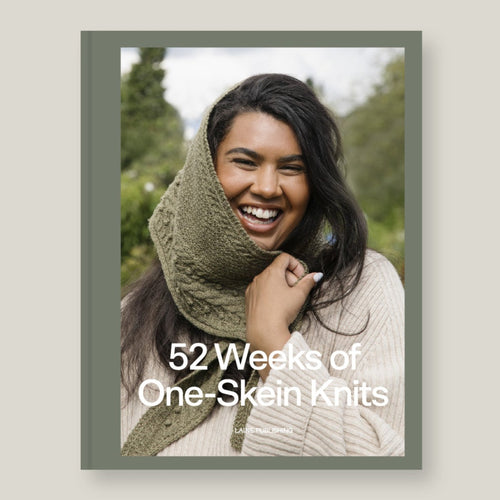 Book over titled '52 Weeks of One-Skein Knits' shown against a light beige background. Laine Publishing.