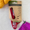 Milward 4.5 inch Thread Snips in plastic-free retail packaging. Yellow & purple yarn in the background.