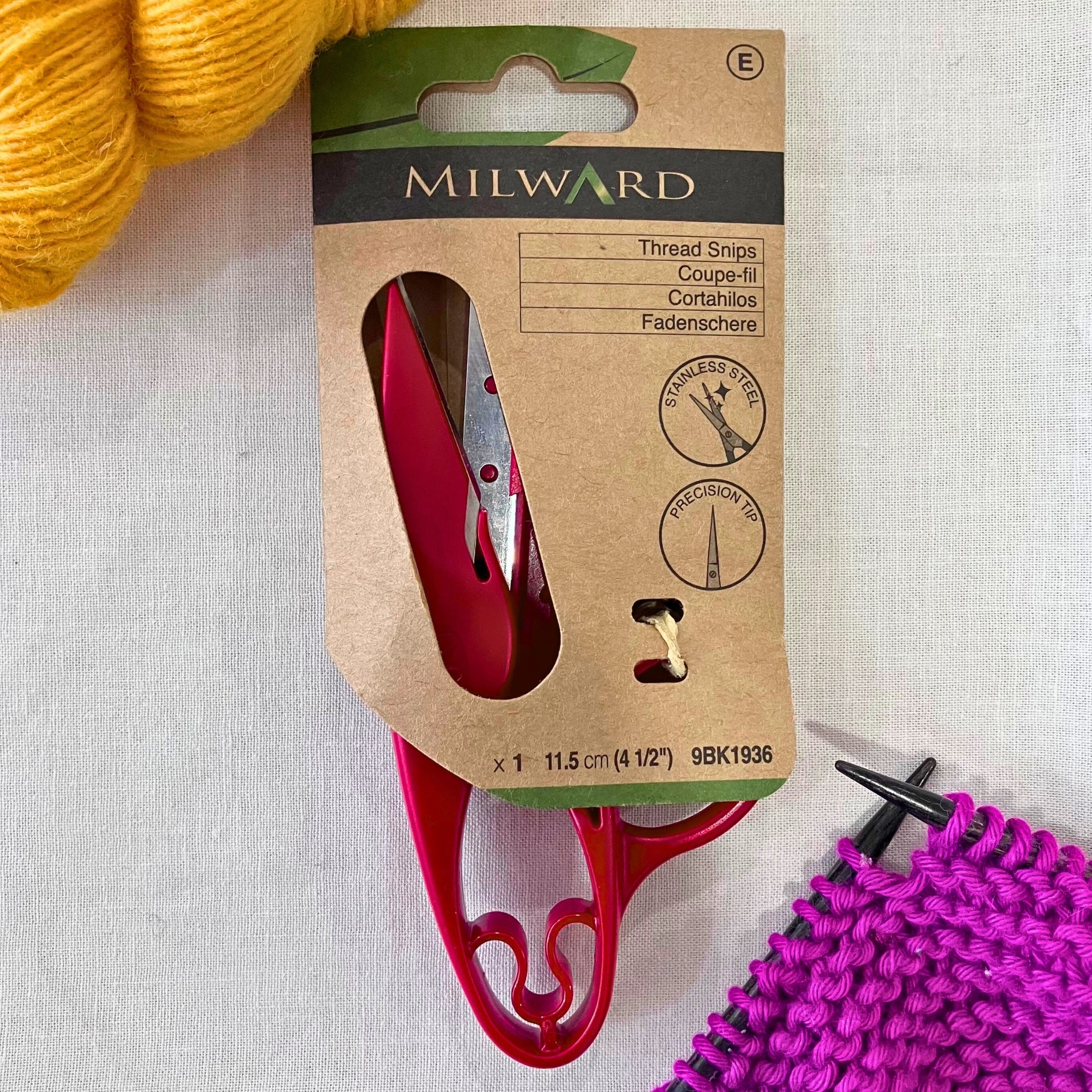 Milward 4.5 inch Thread Snips in plastic-free retail packaging. Yellow & purple yarn in the background.