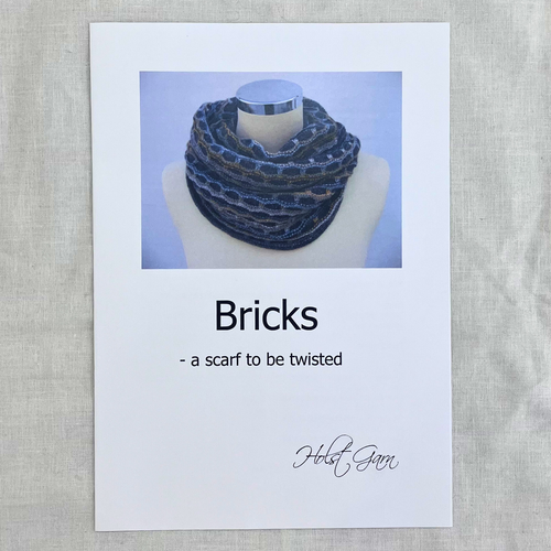 Bricks Scarf knitting pattern by Holst Garn — cover showing finished twisted scarf.