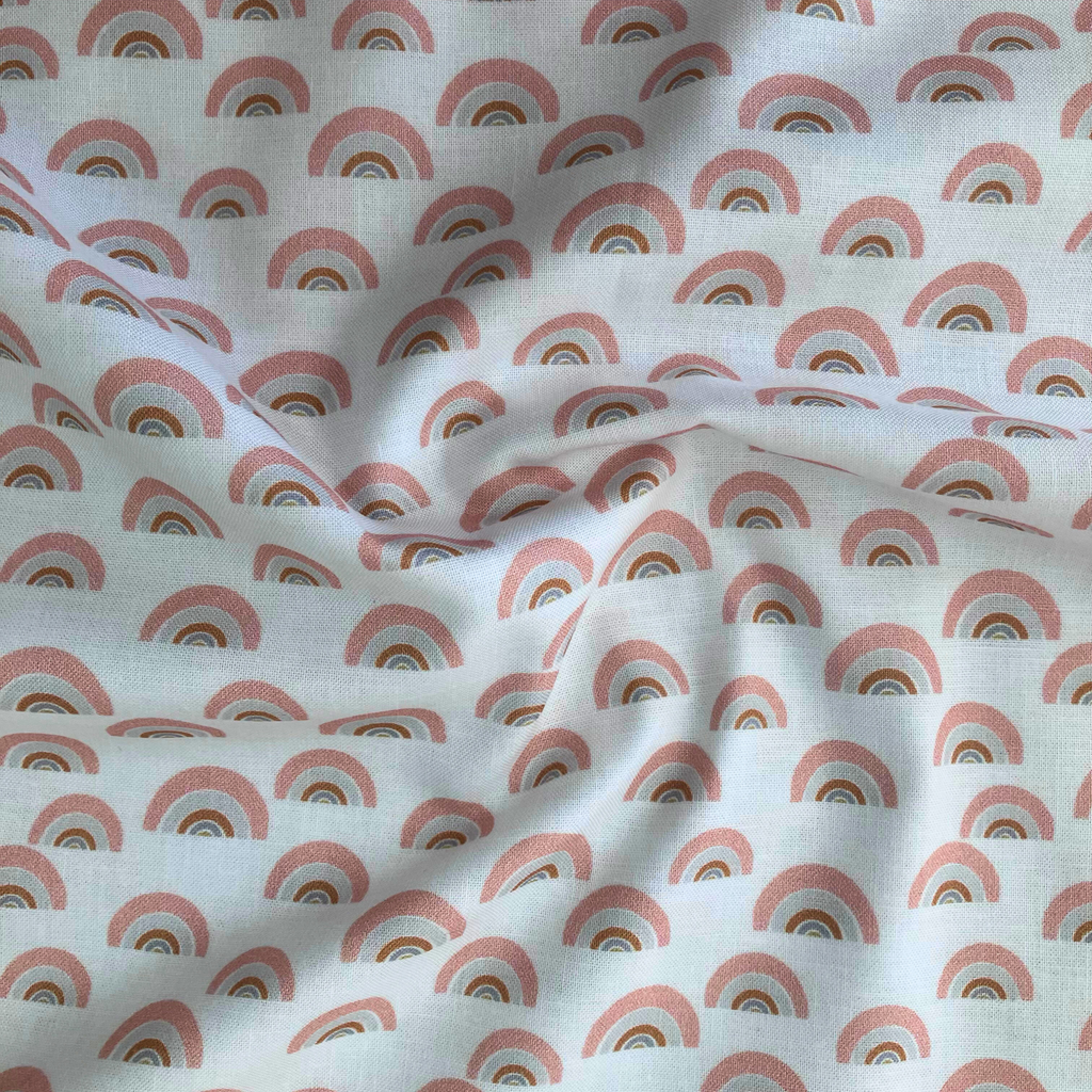 100% cotton quilting fabric — gold, grey & salmon rainbow pattern on a white background. 44/45in width.