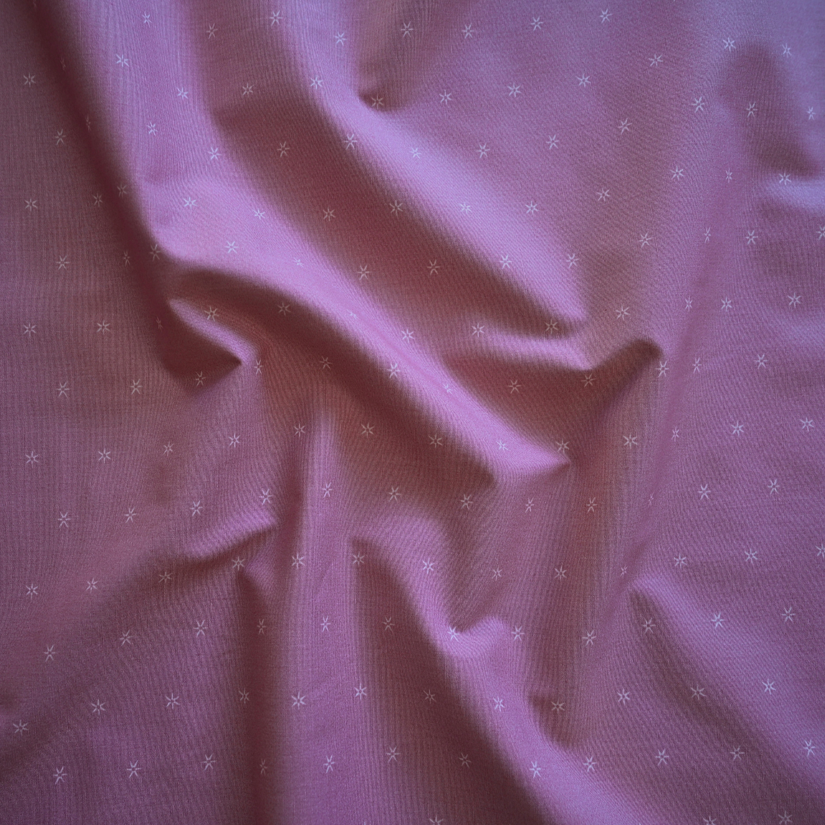 100% cotton quilting fabric — small stars on light grey-pink fabric. 44/45in width.