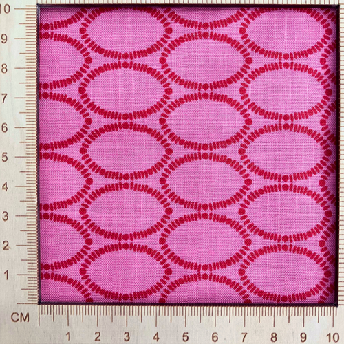 4"x4" scale — 100% cotton quilting fabric — geometric ovals in red on a rich raspberry background. 44/45in width.