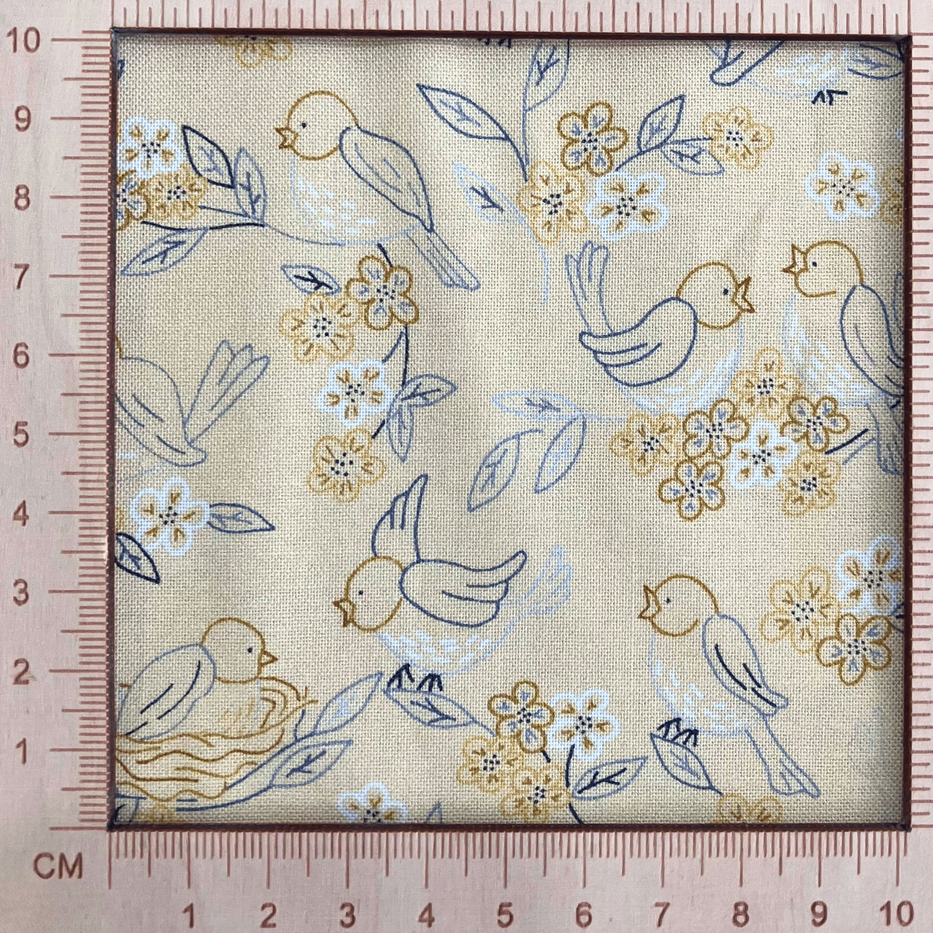 4"x4" scale — 100% cotton quilting fabric — buttery yellow fabric with blue and grey line-drawn birds, nests, and blooms. 44/45in width.