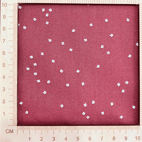 4"x4" scale —  100% cotton quilting fabric — warm red fabric with Tiny white confetti blossoms. 44/45in width.