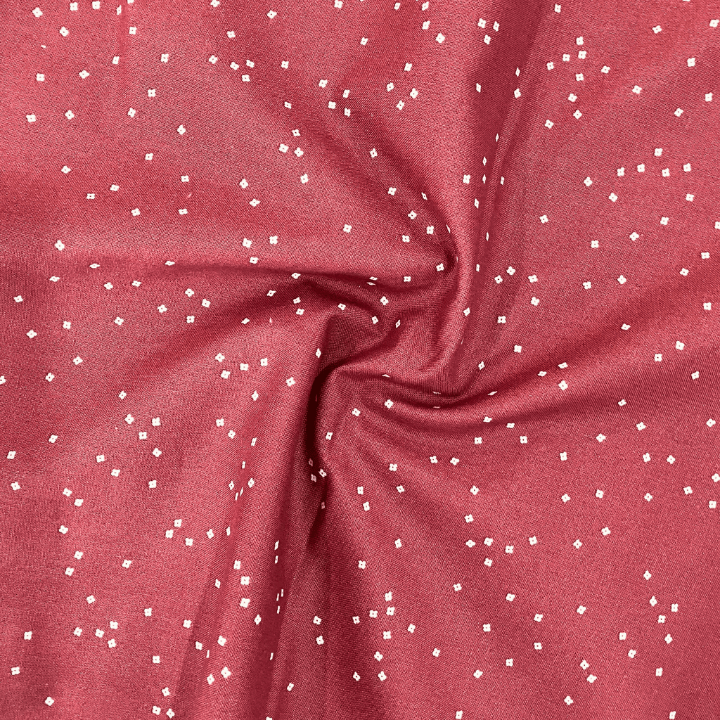100% cotton quilting fabric — warm red fabric with Tiny white confetti blossoms. 44/45in width.