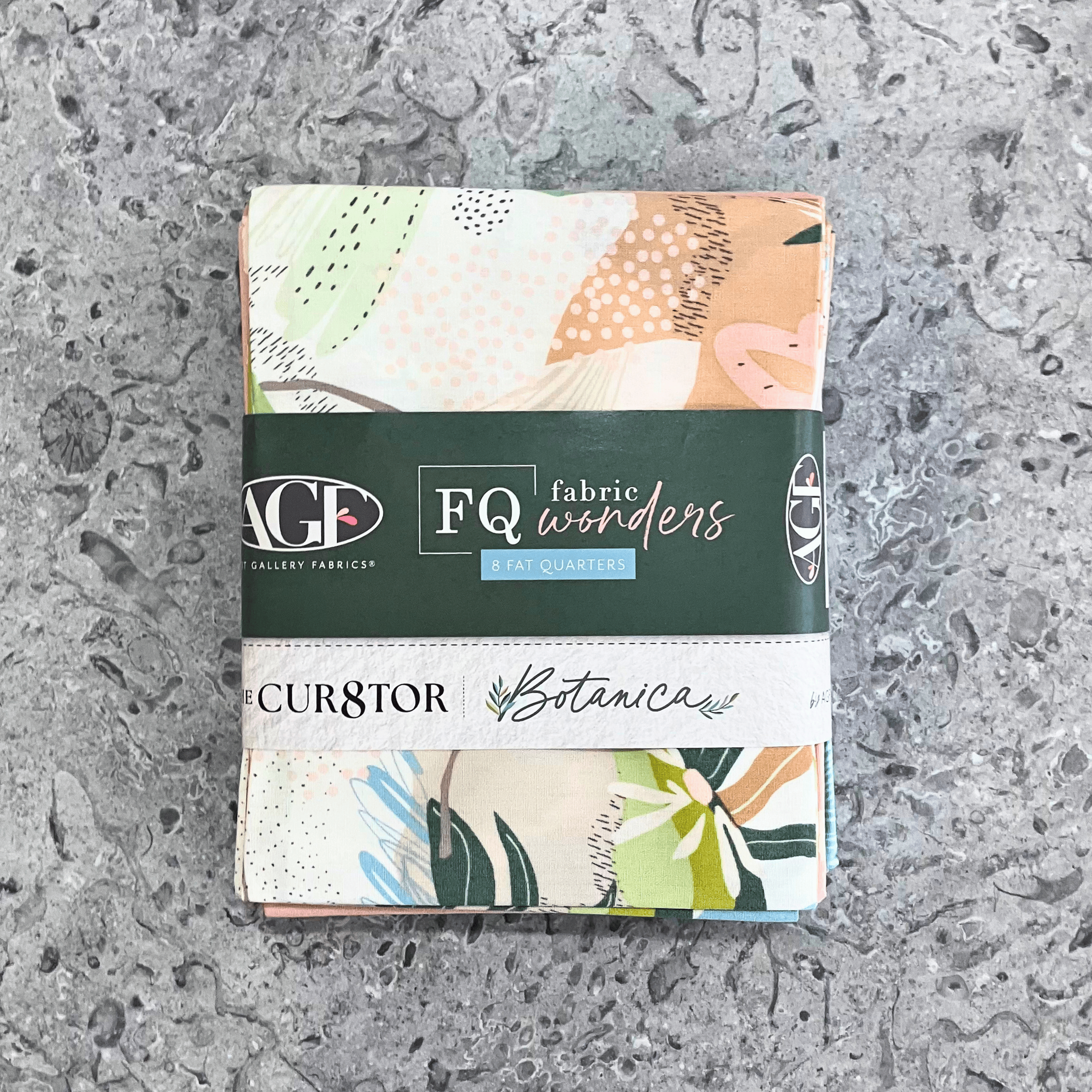 100% cotton quilting fabric — set of eight fat quarters — fabrics with florals, leaves, and organic textures patterns of soft pinks & greens. 'Art Gallery Fabrics Fat Quarters Fabric Wonders Botanica' label visible.