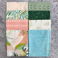 100% cotton quilting fabric — set of eight fat quarters — various fabrics with florals, leaves, and organic textures patterns of soft pinks & greens.