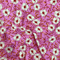 100% cotton quilting fabric — pink fabric with white flowers with red & yellow centres. 44/45in width.