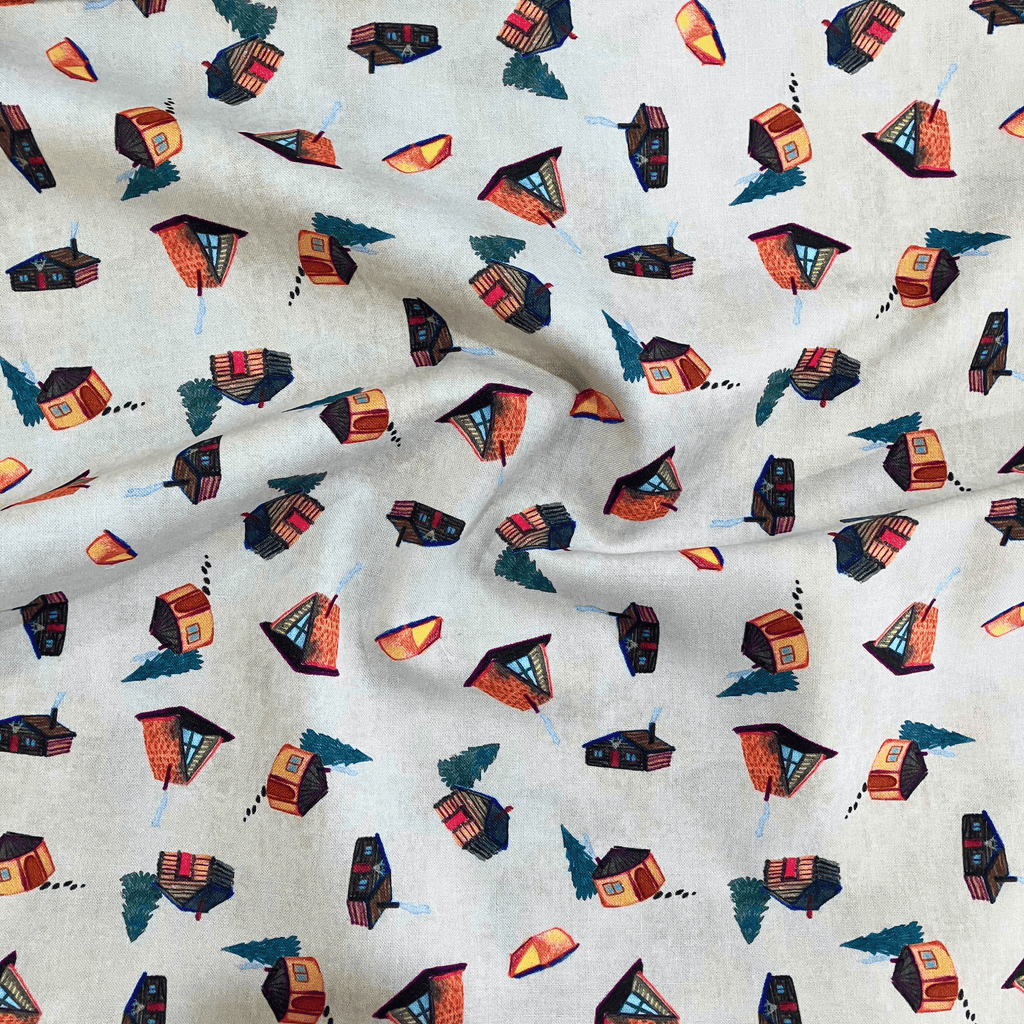 100% cotton quilting fabric — beige fabric with watercolour-style cabins, yurts, and trees. 44/45in width.