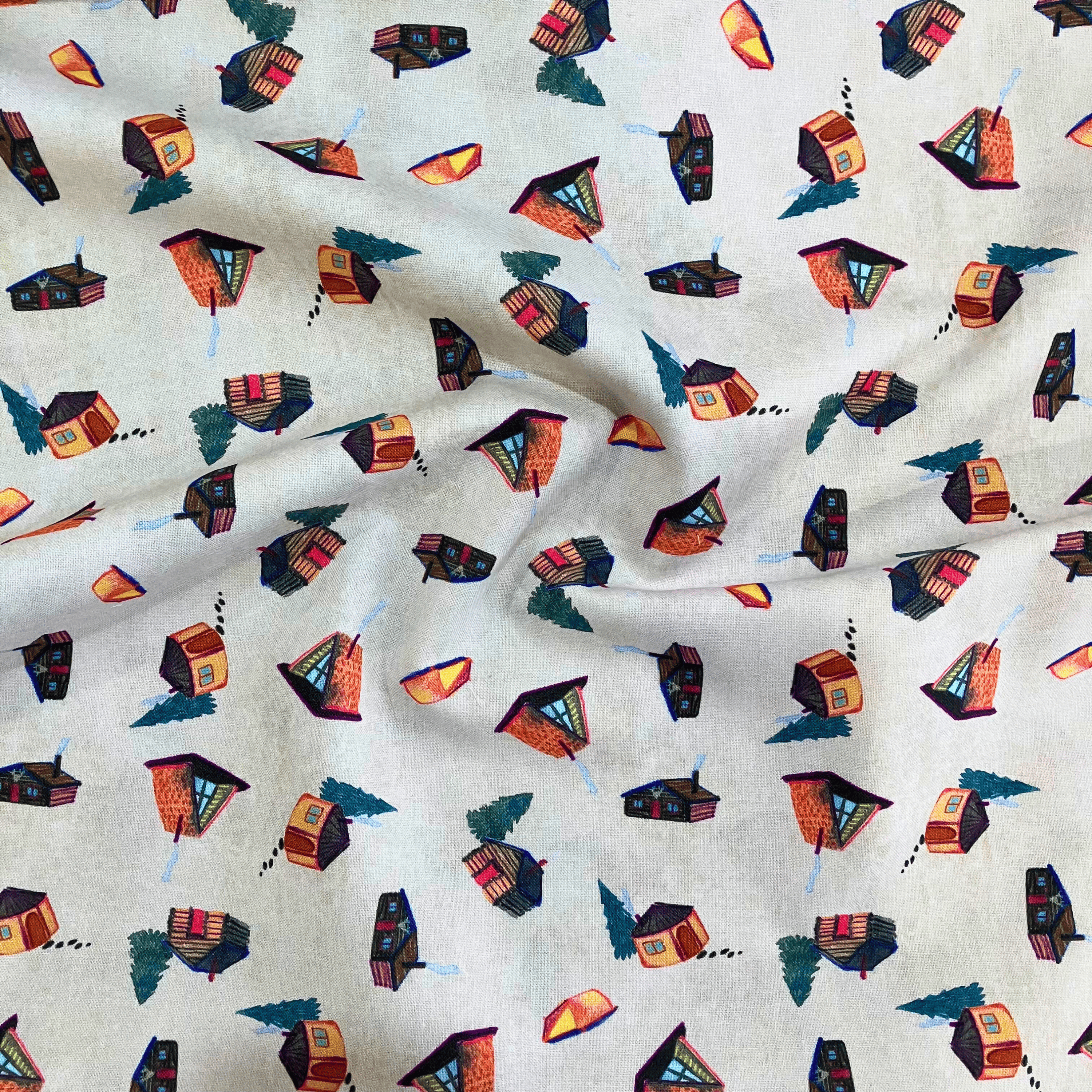 100% cotton quilting fabric — beige fabric with watercolour-style cabins, yurts, and trees. 44/45in width.