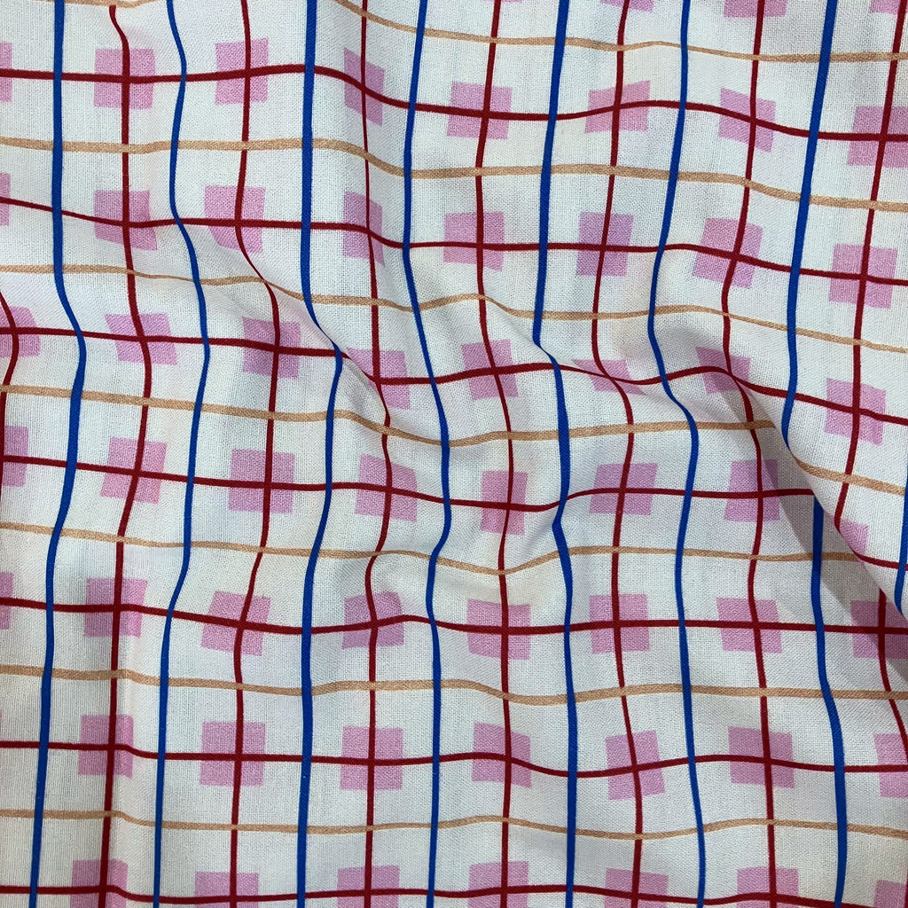 100% cotton quilting fabric — Cream fabric with orange, blue, and red stripes intersect on pink squares. 44/45in width.