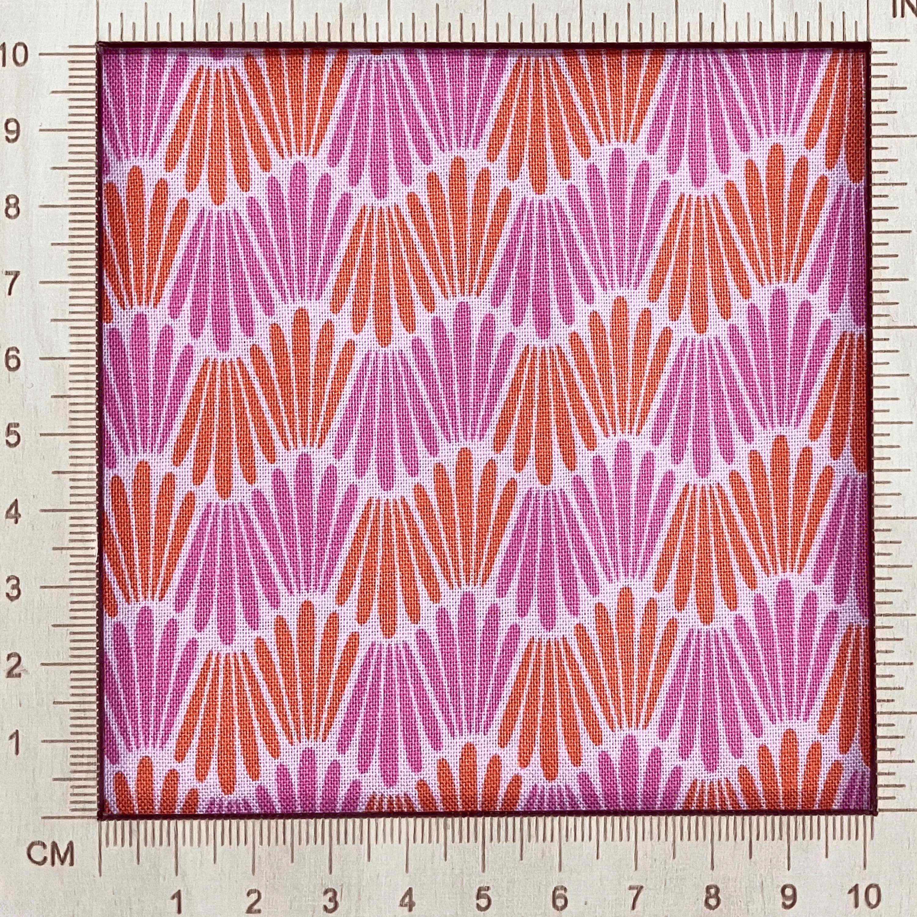 4"x4" scale — 100% cotton quilting fabric — fabric with pink & orange wavy lines. 44/45in width.