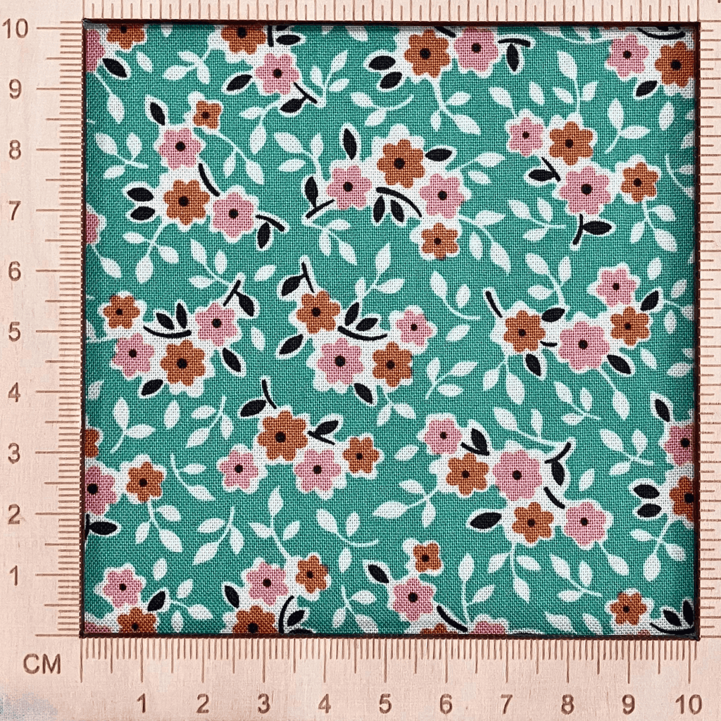 4"x4" scale — 100% cotton quilting fabric — bright green fabric with small pink & orange flowers. 44/45in width.