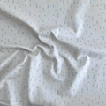 100% cotton quilting fabric — light beige fabric with grey and blue x’s. 44/45in width.