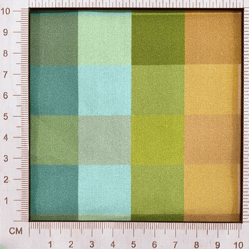 4"x4" scale — 100% cotton quilting fabric — Orange, blue, and green checkered print. 44/45in width.