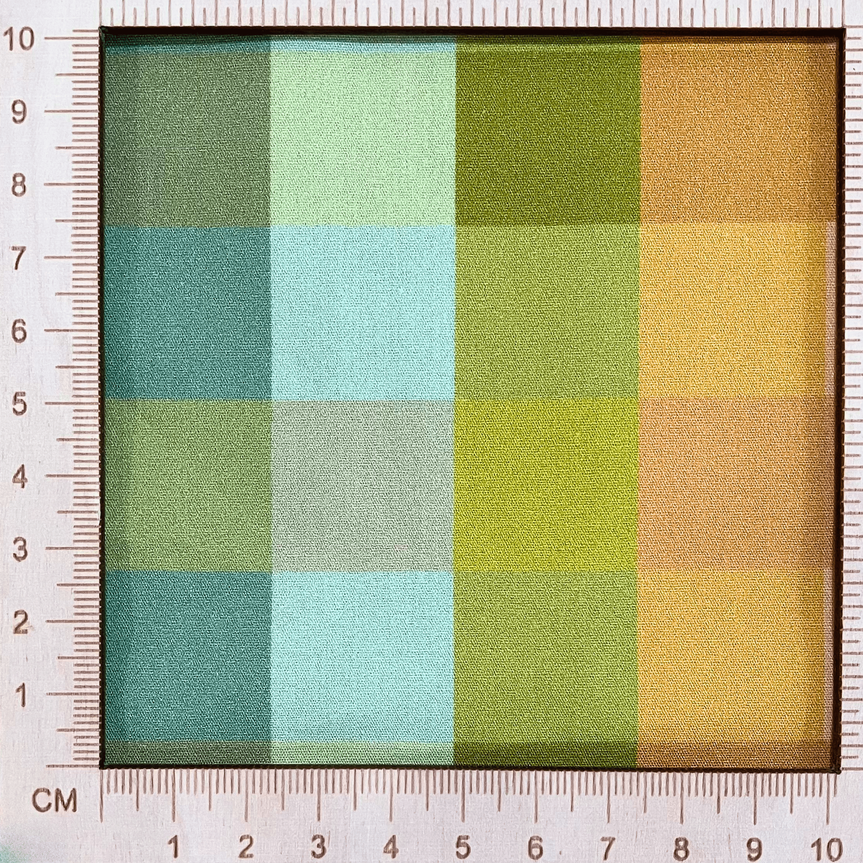 4"x4" scale — 100% cotton quilting fabric — Orange, blue, and green checkered print. 44/45in width.