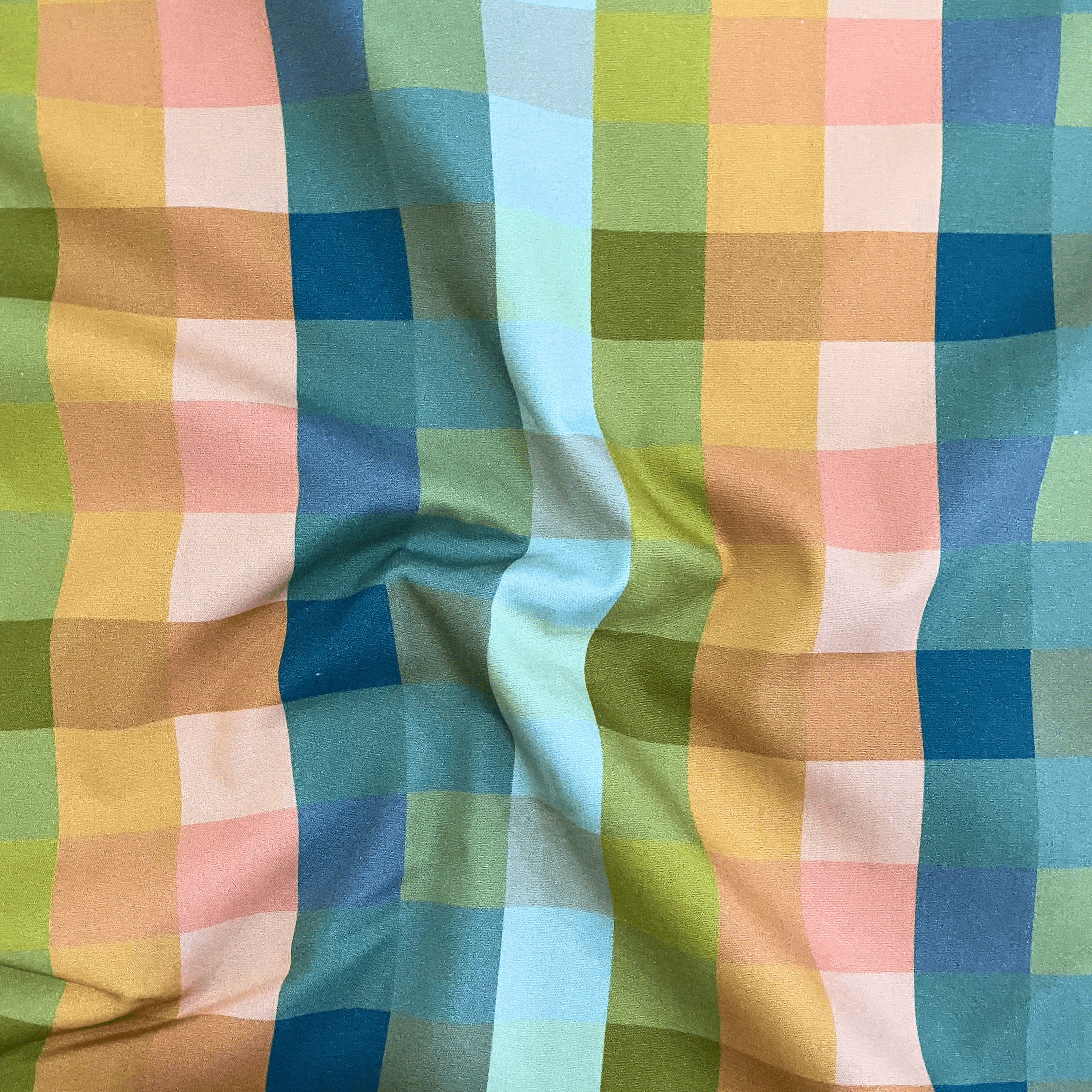 100% cotton quilting fabric — Orange, blue, and green checkered print. 44/45in width.