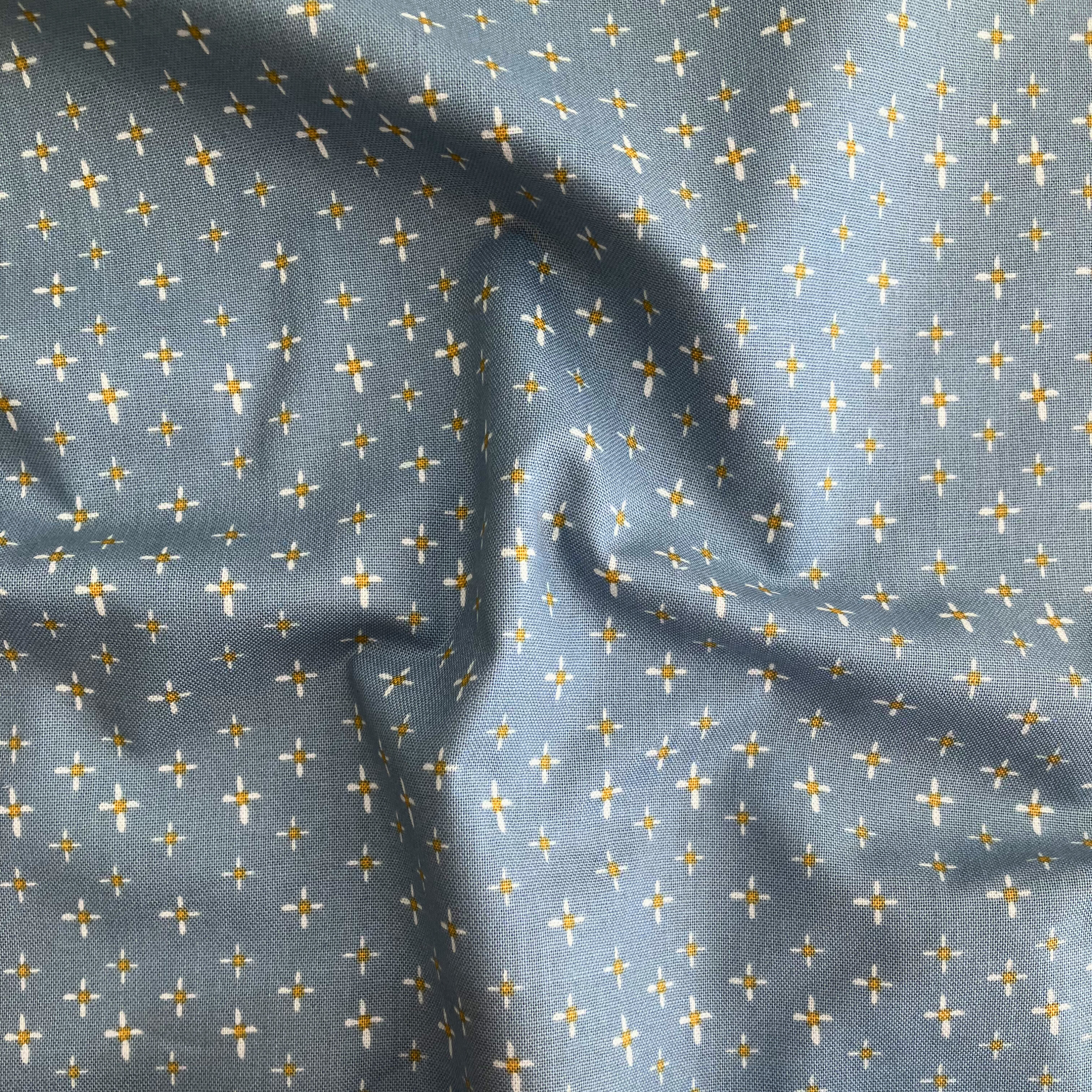 100% cotton quilting fabric — white & yellow daisies on dusty blue. 43/44in width.