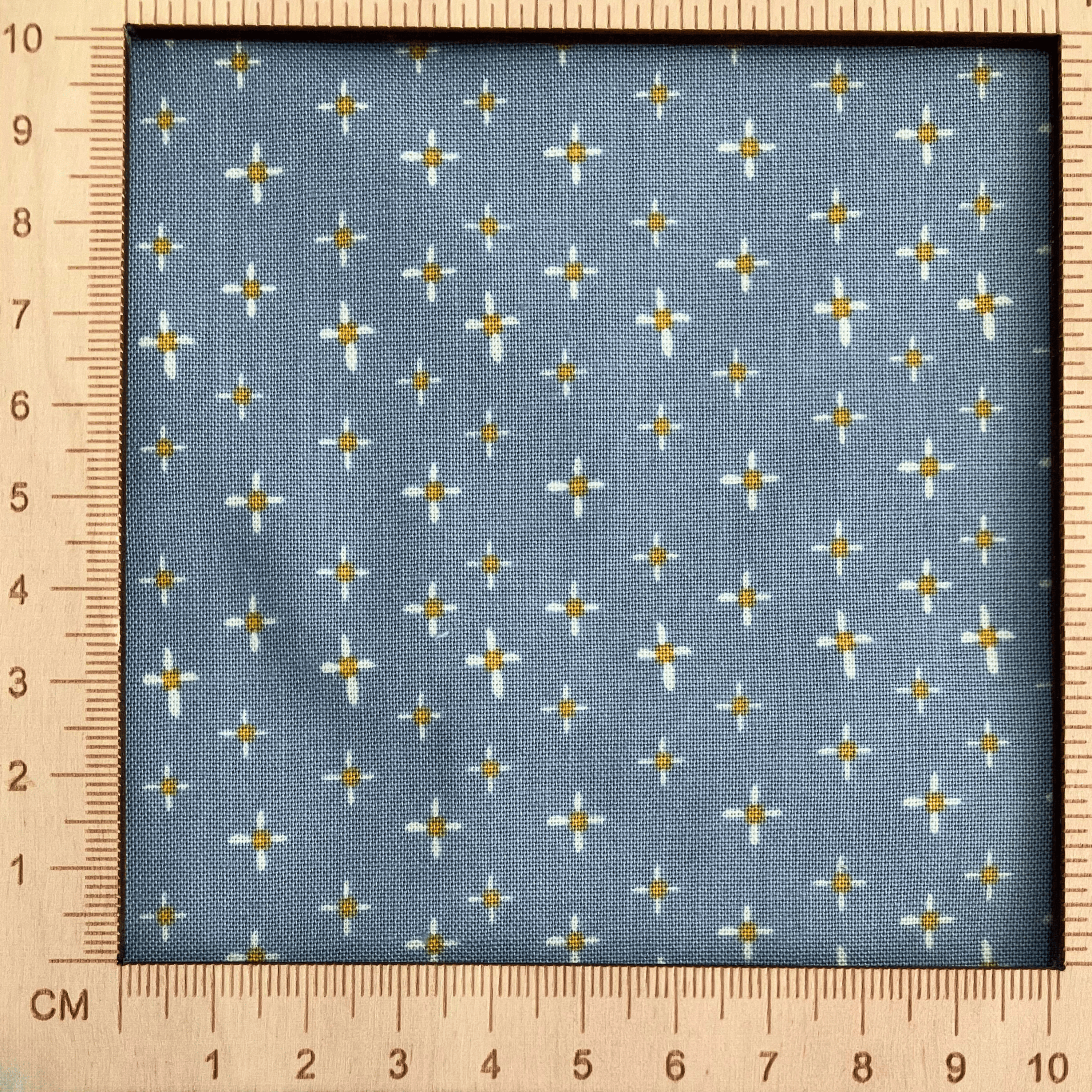 4"x4" scale — 100% cotton quilting fabric — white & yellow daisies on dusty blue. 43/44in width.