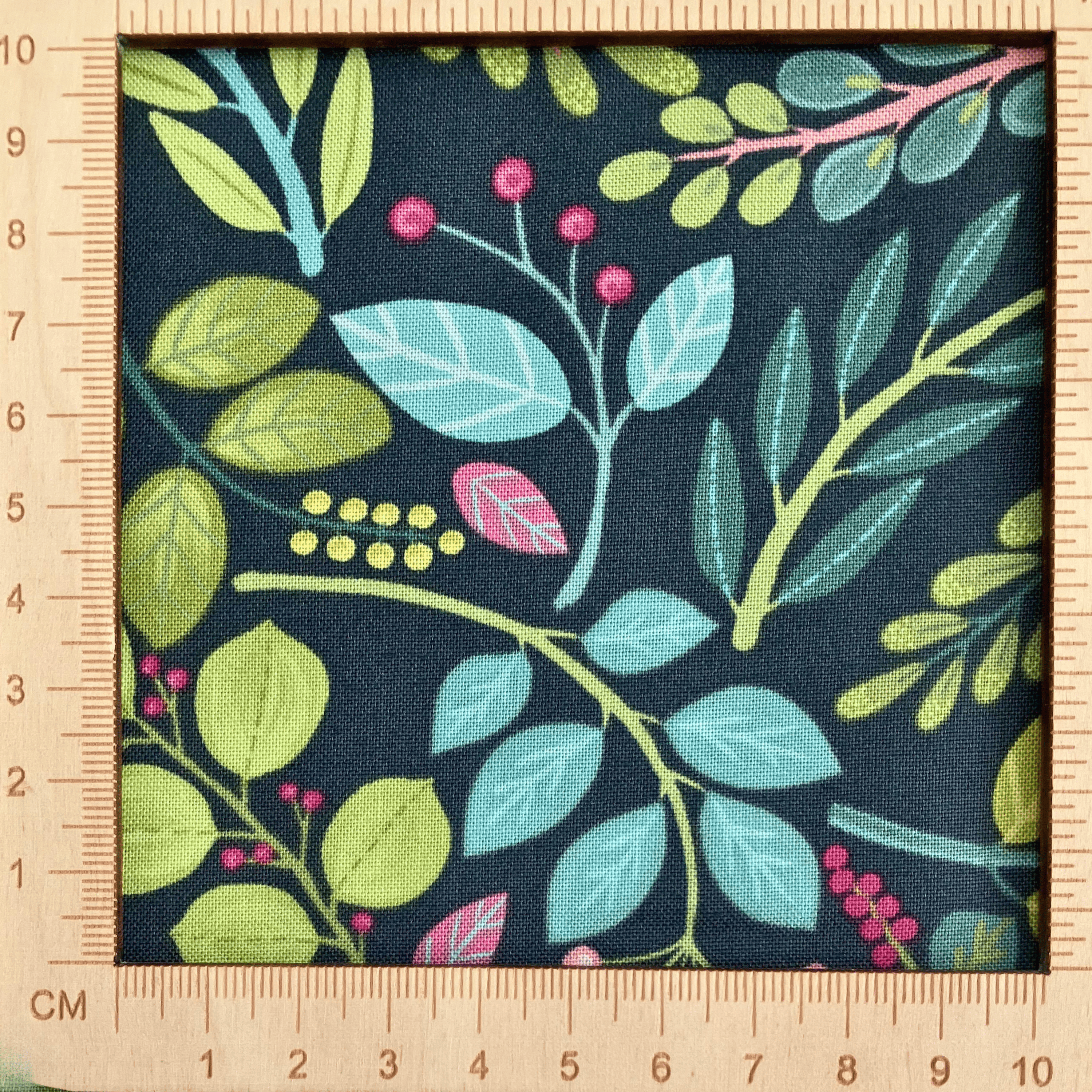 4"x4" scale — 100% cotton quilting fabric — pink, teal & green leaves on dark blue-green. 43/44in width.