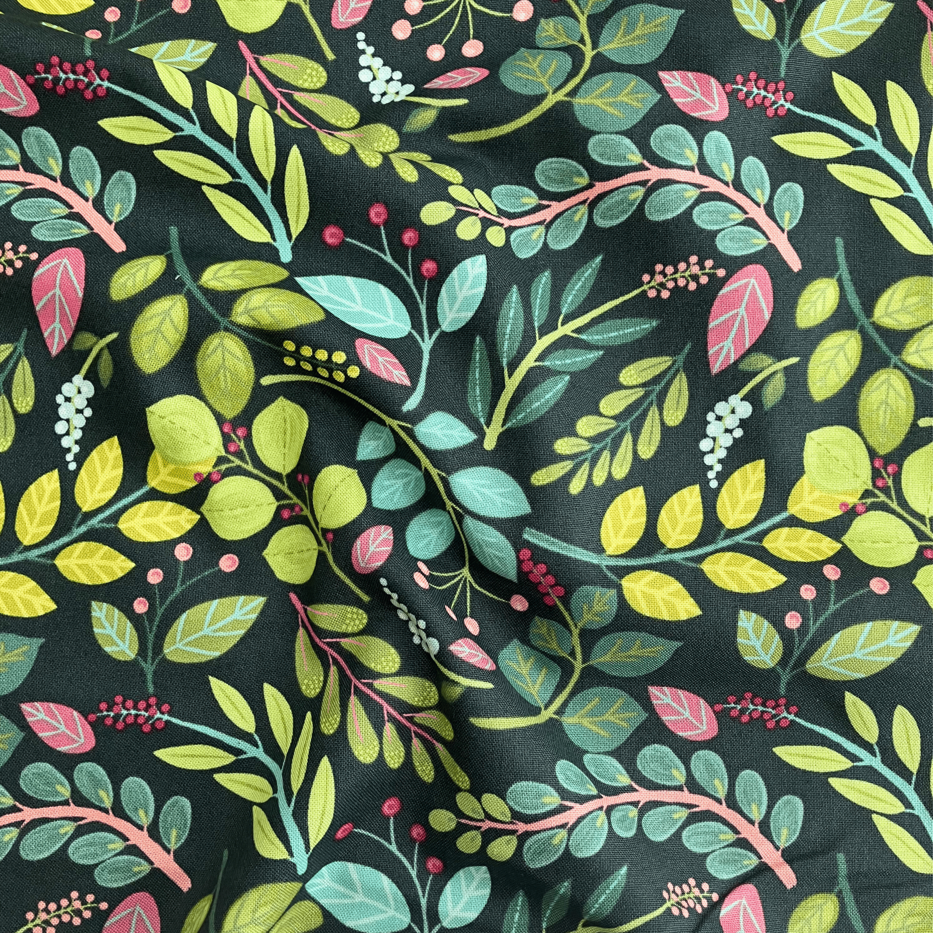 100% cotton quilting fabric — pink, teal & green leaves on dark blue-green. 43/44in width.