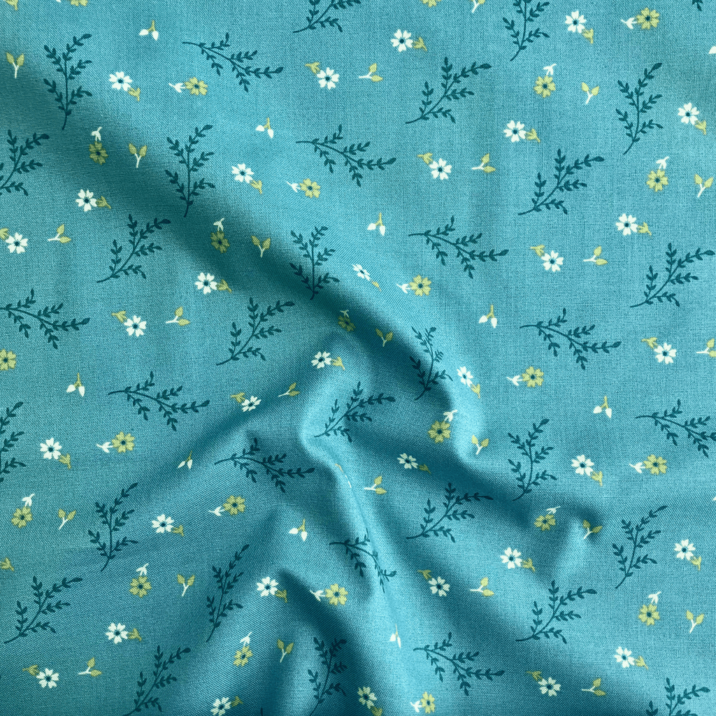 100% cotton quilting fabric — white flowers & green leaves on teal. 43/44in width.