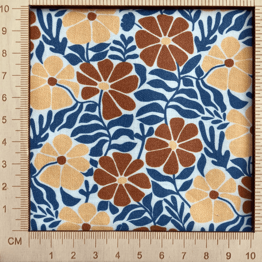 4"x4" scale — 100% cotton quilting fabric — burnt orange & tan flowers with blue-grey leaves on white. 43/44in width.