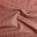 100% cotton quilting fabric — white dot diamonds on muted rose. 43/44in width.