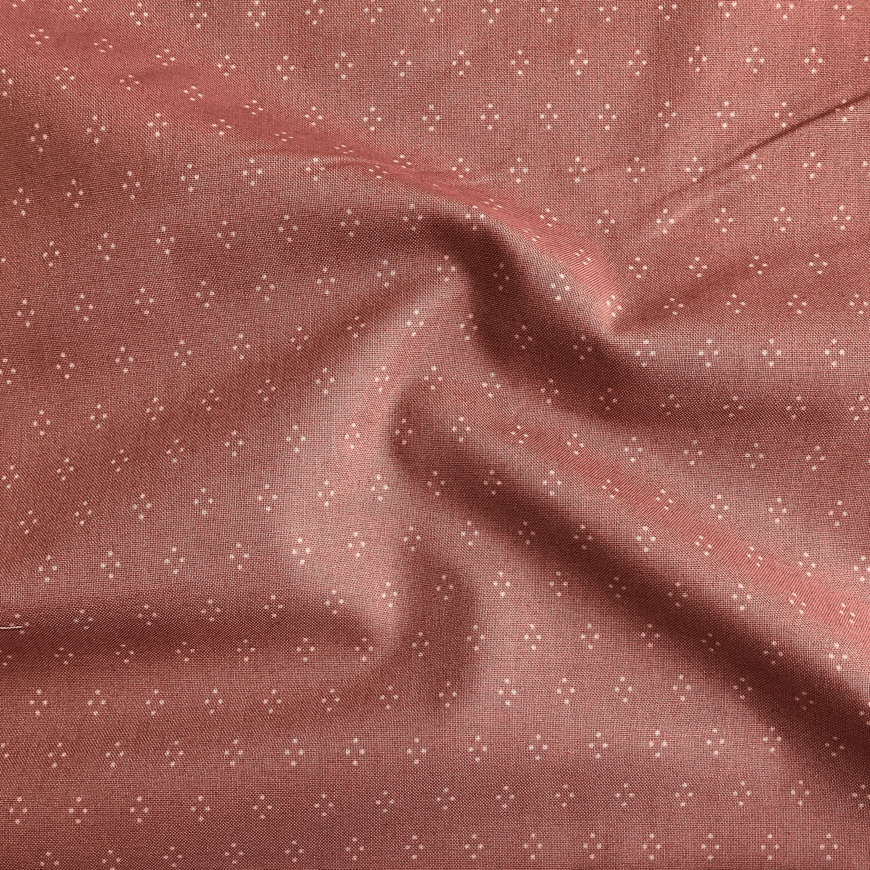 100% cotton quilting fabric — white dot diamonds on muted rose. 43/44in width.