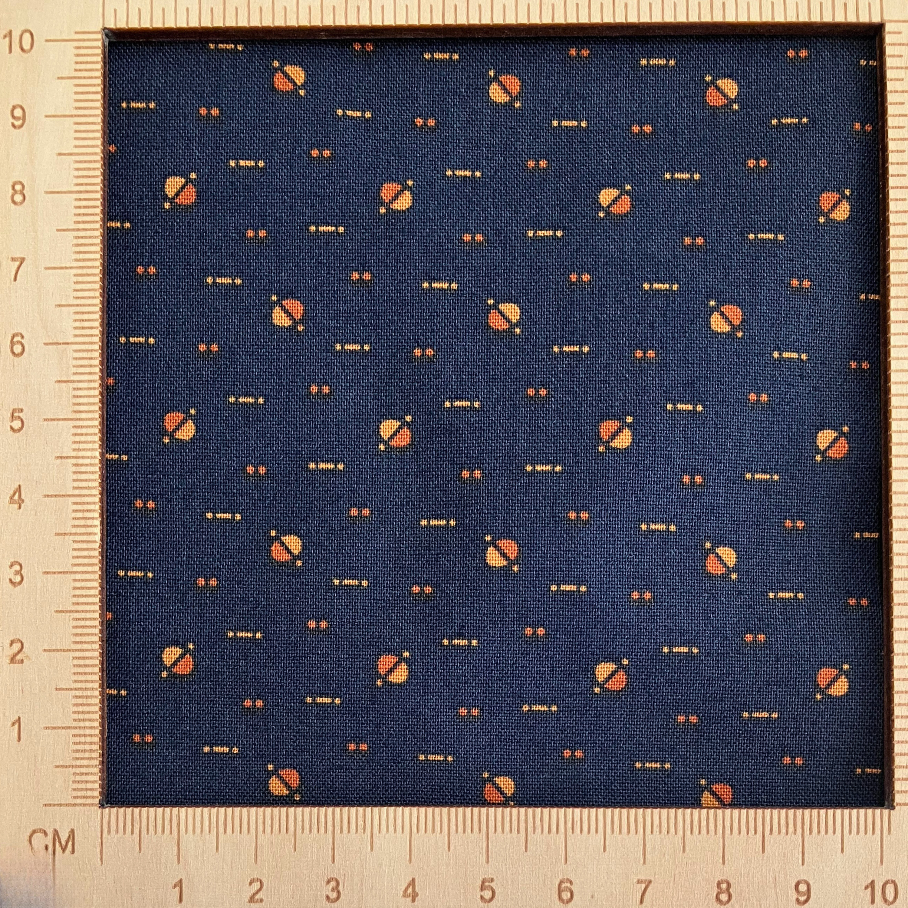 4"x4" scale — 100% cotton quilting fabric — yellow & orange dots on dark indigo blue. 43/44in width.