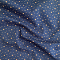100% cotton quilting fabric — yellow & orange dots on dark indigo blue. 43/44in width.