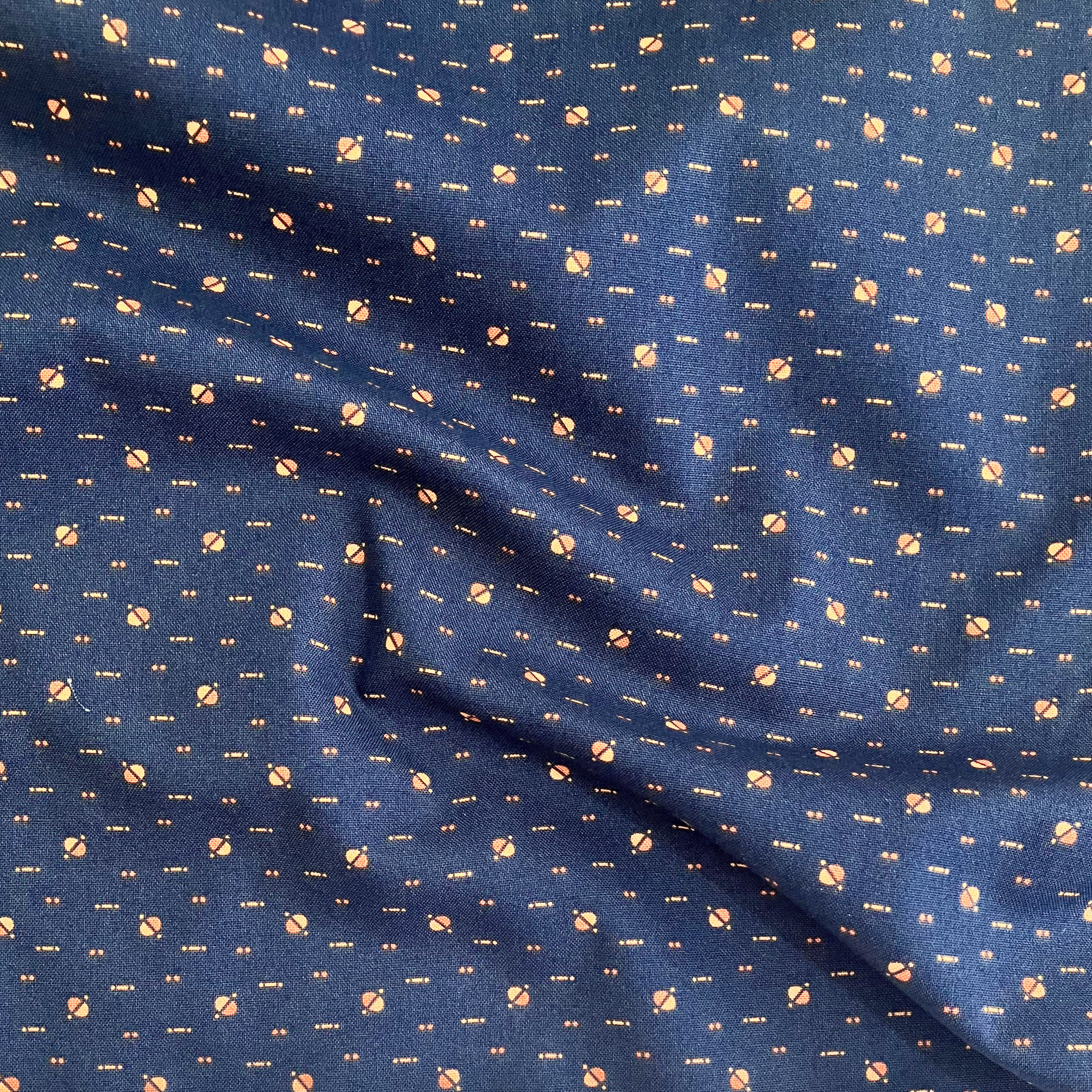 100% cotton quilting fabric — yellow & orange dots on dark indigo blue. 43/44in width.