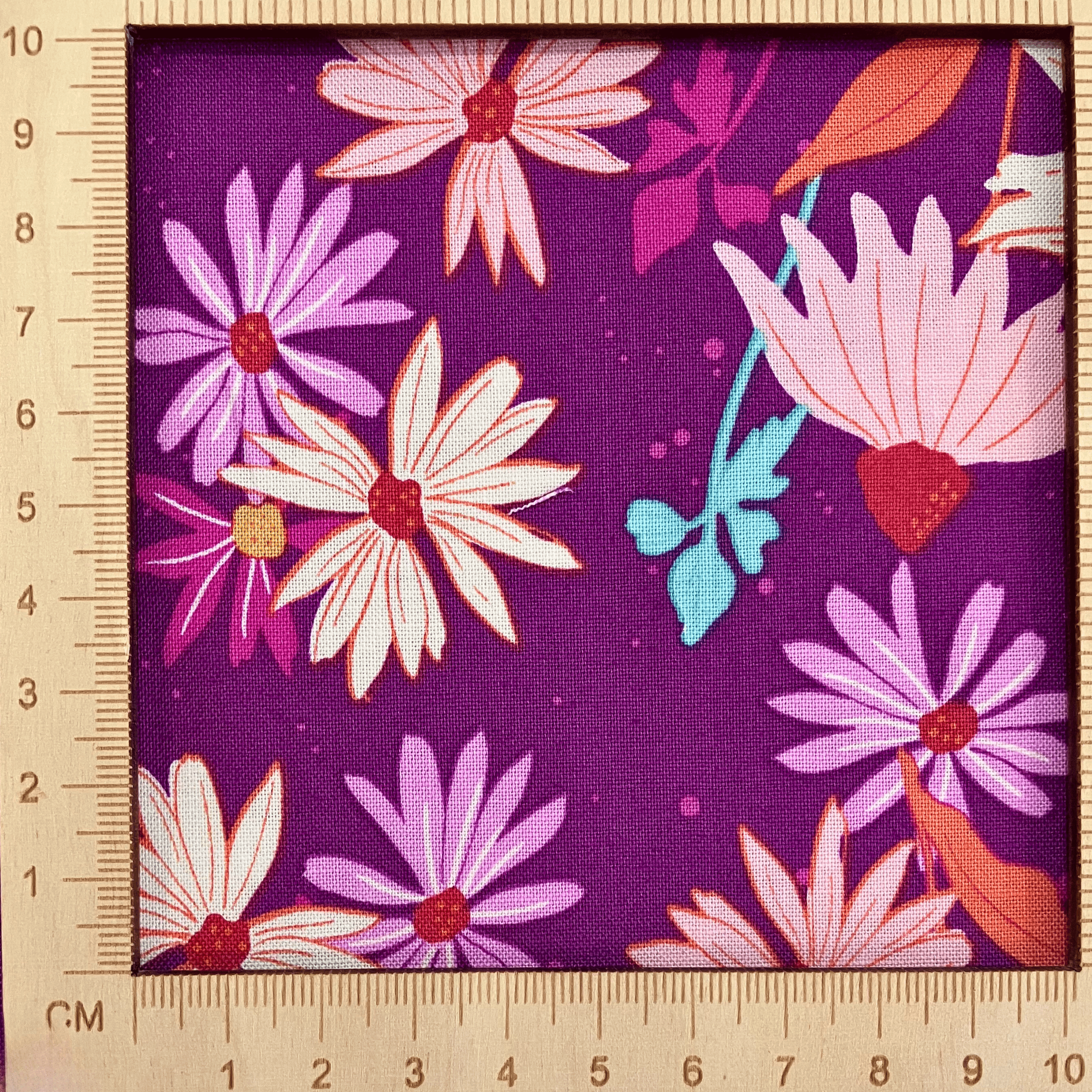 4"x4" scale — 100% cotton quilting fabric — colourful flowers on purple. 44/45in width.
