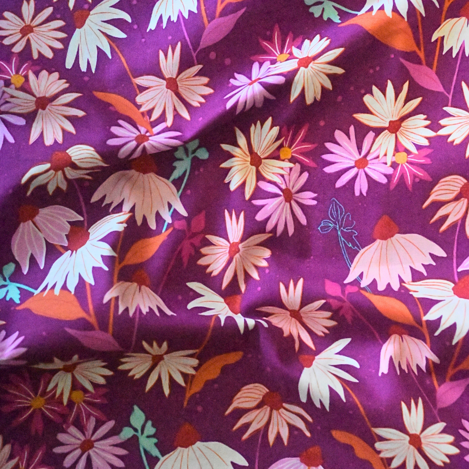 100% cotton quilting fabric — colourful flowers on purple. 44/45in width.