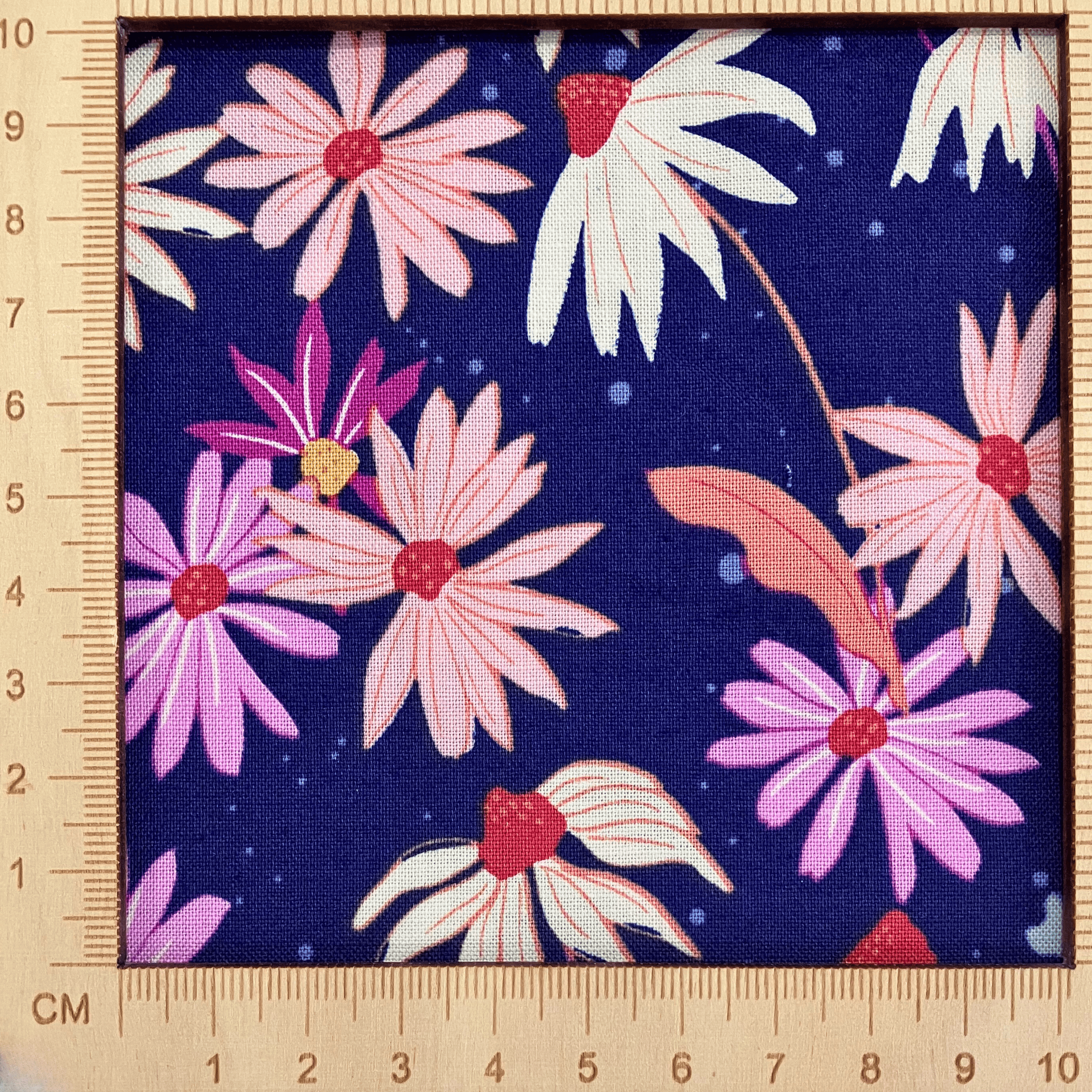 4"x4" scale — 100% cotton quilting fabric — pink, white & orange flowers on navy. 44/45in width.