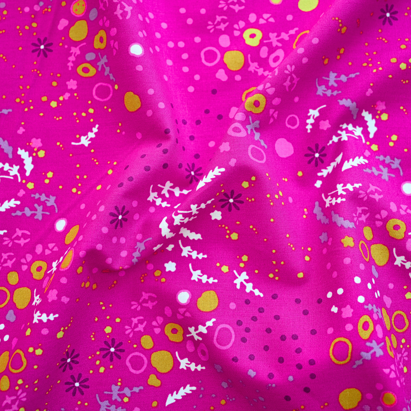 100% cotton quilting fabric — colourful florals & abstract patterns on vibrant pink. 44/45in width.