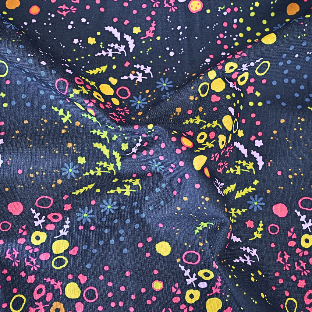 100% cotton quilting fabric — colourful abstract patterns on dark blue-grey. 44/45in width.
