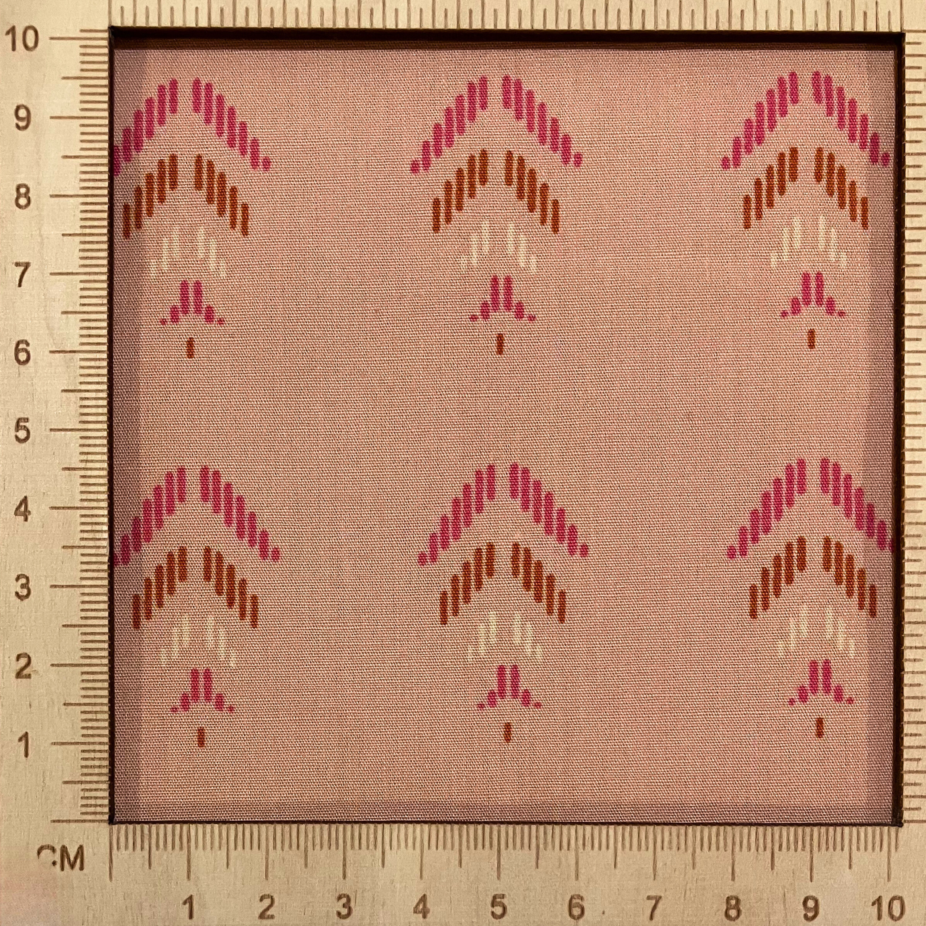 4"x4" scale — 100% cotton quilting fabric — pink & orange feather-like shapes on light coral. 44/45in width.
