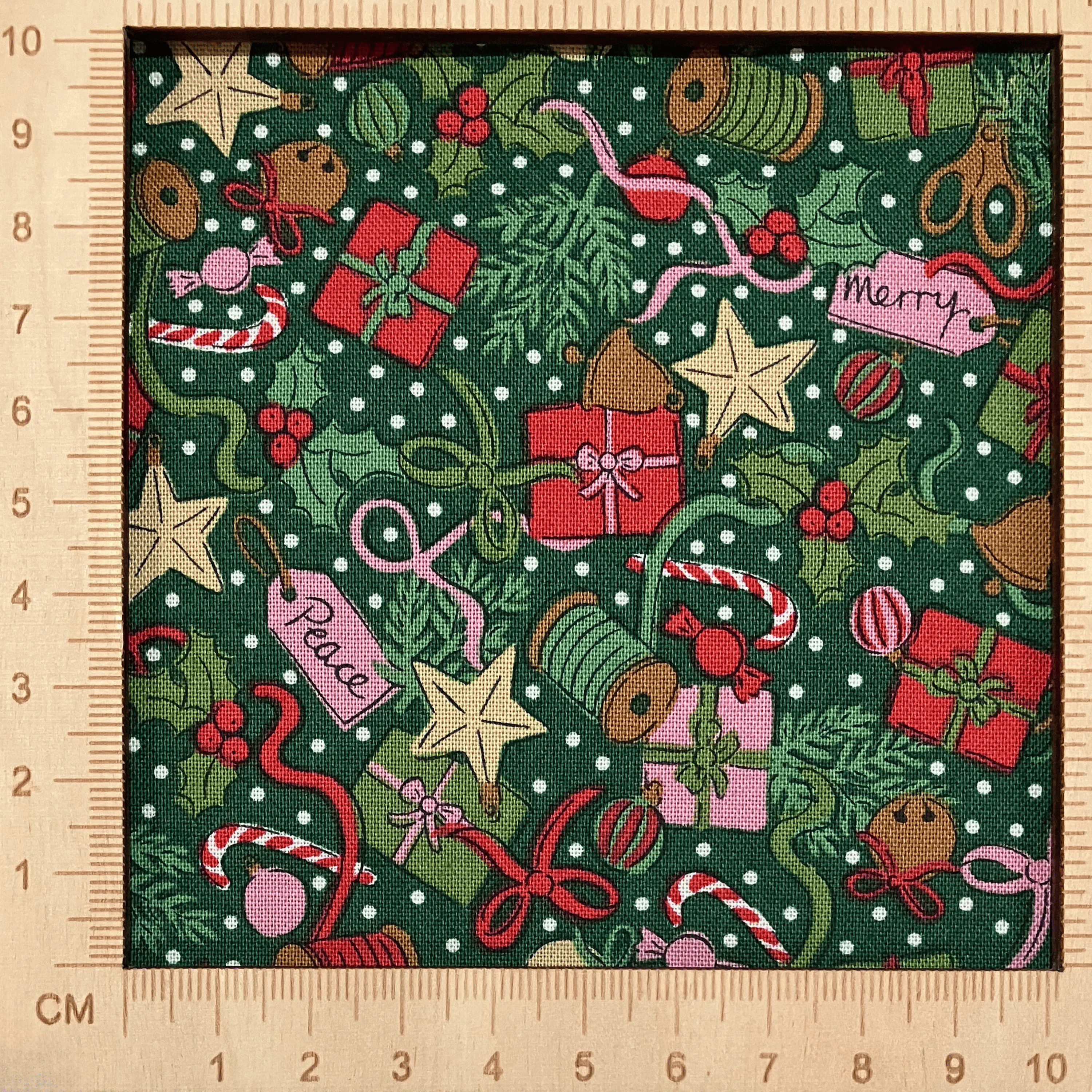 4"x4" scale — Liberty Fabrics Lasenby cotton — presents, ribbons, bows & holiday motifs on green. 44/45in width.