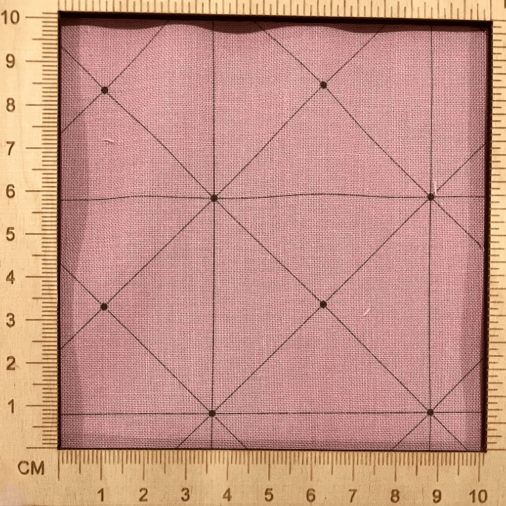 4"x4" scale — 100% cotton quilting fabric — thin green grid lines on dusty pink. 44in width.