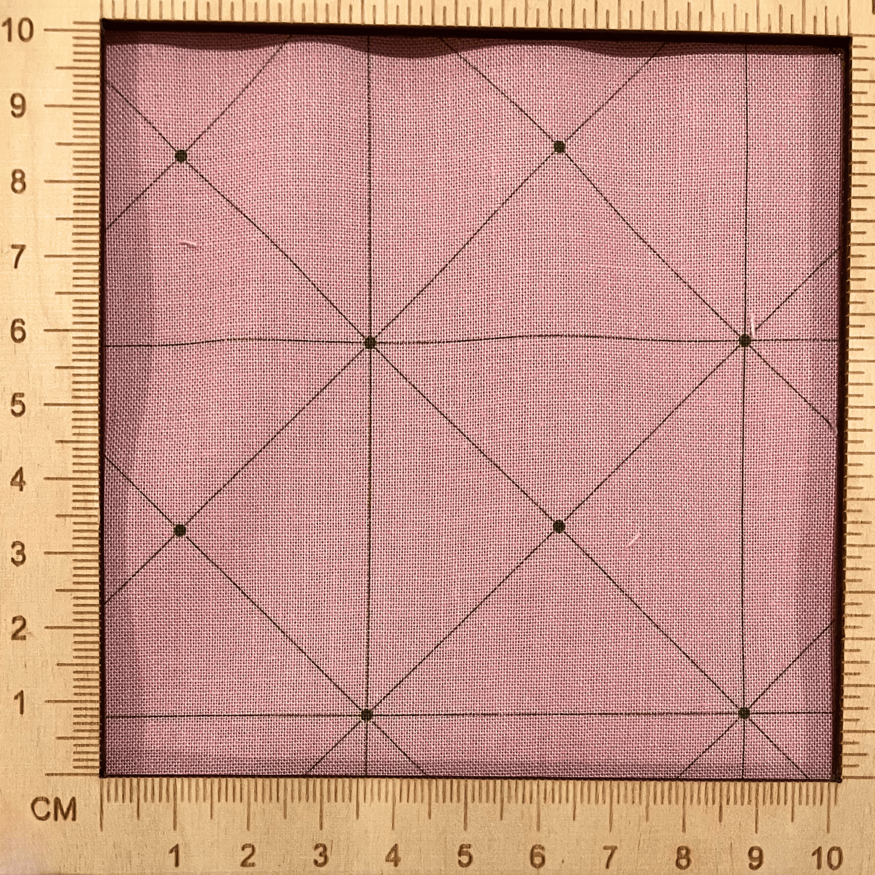 4"x4" scale — 100% cotton quilting fabric — thin green grid lines on dusty pink. 44in width.